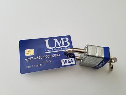 Photo of a UMB debit card with a padlock attached