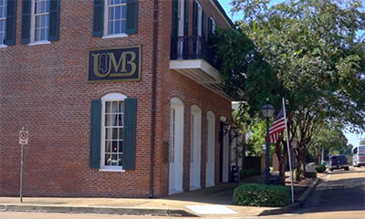 Brick building with United Mississippi Bank sign on it.