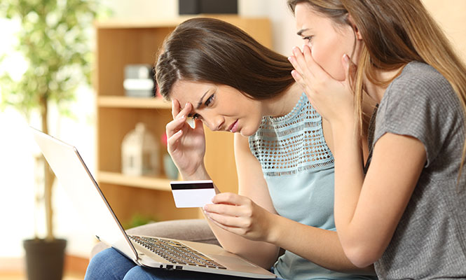 Women looking at computer very worried.